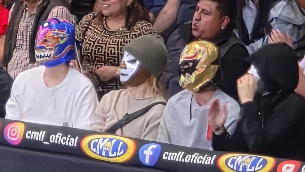 BTS members Suga Jimin Jin and Jungkook watch a wrestling match in Mexico