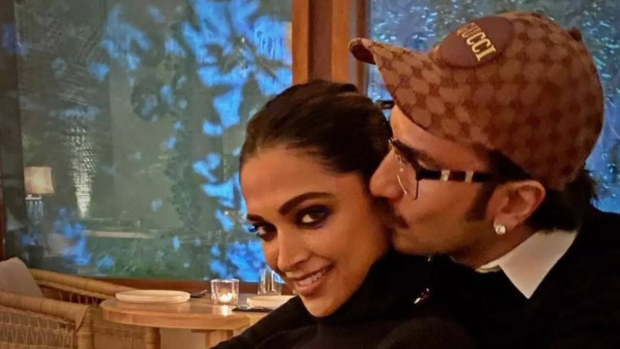 Ranveer Singh sweetly plants a kiss on Deepika Padukone's cheek as the duo head to the airport holding hands - WATCH